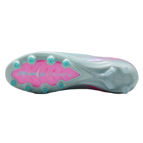 The underside of a light grey Nike soccer cleat, featuring a bright pink Air Zoom section and teal-colored conical studs.