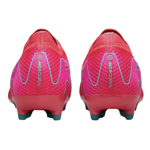 Rear view of two bright pink Nike Mercurial soccer cleats on a black background. Features vertical "MERCURIAL" branding on the heels and teal-tipped studs.