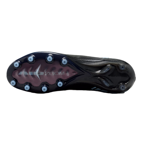 Bottom view of a black Nike soccer cleat with light blue circular studs. A translucent pink window on the sole displays the text "AIR ZOOM" in silver.