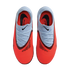Top-down view of bright red and light blue Nike Phantom soccer cleats on a black background, featuring textured uppers and black swoosh logos.