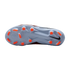 Bottom view of a light blue Nike soccer cleat with orange studs against a black background.