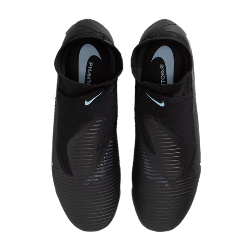 Top-down view of black Nike Phantom soccer cleats with light blue branding and ribbed texture on the upper, set against a black background.