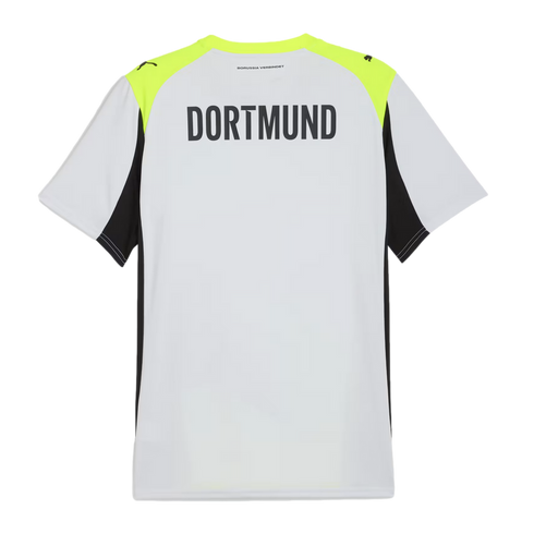 Back of a white Puma soccer jersey featuring large black "DORTMUND" text, neon yellow shoulder panels, and black side inserts.
