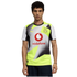 Man with curly hair wearing a yellow and grey geometric Puma BVB soccer jersey with a red Vodafone logo, set against a solid black background.