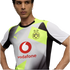 A man wearing a white, grey, and neon yellow Borussia Dortmund soccer jersey featuring a Vodafone sponsor logo, Puma branding, and geometric patterns.
