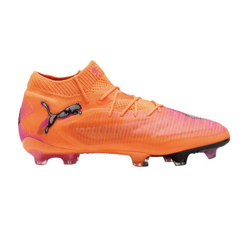 Side profile of a neon orange and pink Puma soccer cleat with a textured upper and mid-cut collar against a black background.