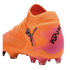 An orange and pink Puma Future soccer cleat with a textured upper, black Puma logo, and "PLAY FREE FUTURE" text on the heel.