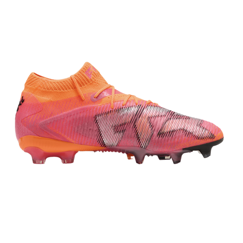 Side view of a Puma Future soccer cleat in vibrant orange and pink with silver diagonal graphics on a black background.