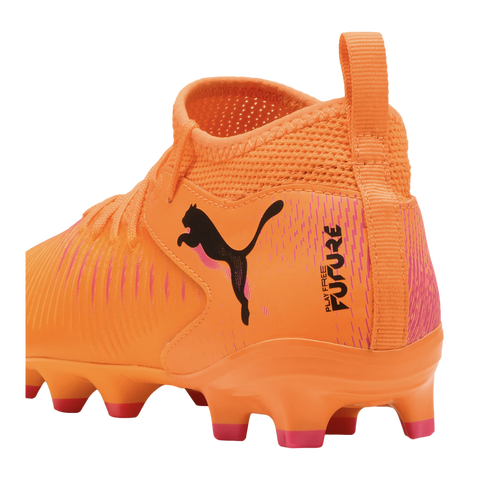 Side-back view of a bright orange Puma Future soccer cleat with pink accents, a sock-like collar, and a black Puma logo on the side.