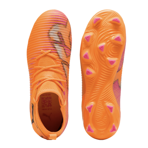 Top and bottom views of bright orange Puma soccer cleats with pink and black striped accents on the upper and pink studs on the soleplate.