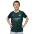 A young boy posing in a dark green Manchester City soccer jersey with geometric triangle patterns, hands on his hips against a black background.