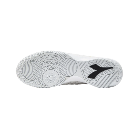 Sole of a white Diadora athletic shoe showing intricate traction patterns and a black brand logo, set against a plain black background.