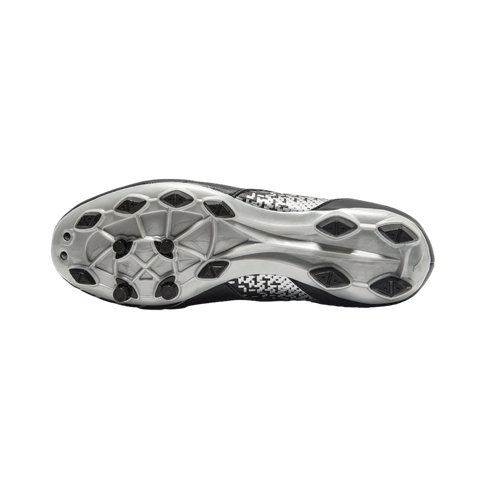 Underside view of a silver soccer cleat featuring black diamond-shaped and circular studs on a silver soleplate with a pixelated pattern.