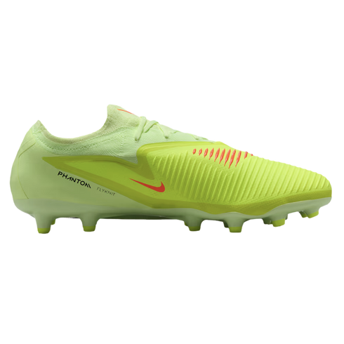 A side profile of a lime green Nike Phantom Flyknit soccer cleat with orange accents and a ridged upper, set against a black background.