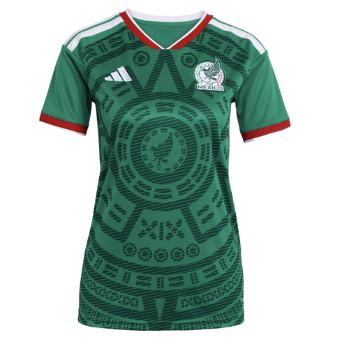 A green Mexico national football team jersey featuring a prominent Aztec-inspired sun stone graphic, white Adidas logo, and team crest with red and white trim.