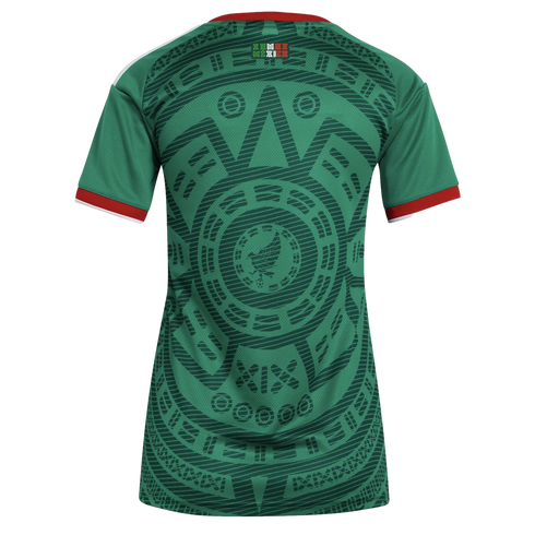 Back view of a green Mexico soccer jersey featuring an intricate dark green Aztec pattern, red and white sleeve trim, and a small "SOMOS MEXICO" logo at the neck.