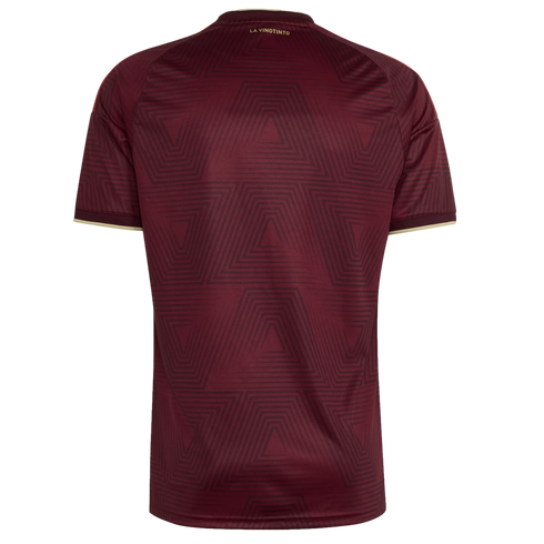 Back view of a burgundy soccer jersey with a tonal geometric triangle pattern. Gold trim on sleeve cuffs and small gold "LA VINOTINTO" text on the back neck.