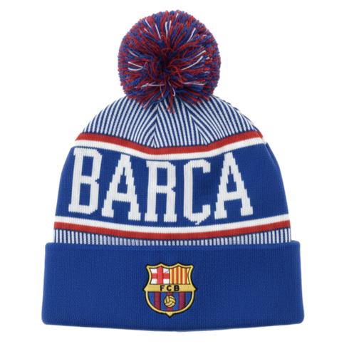 Blue and white striped knit beanie featuring a pom-pom, large "BARCA" lettering, and the FC Barcelona crest on the folded cuff.