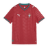 A red Puma Portugal national team soccer jersey with a wavy horizontal pattern and green trim on the v-neck and cuffs.