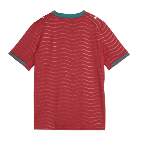 Rear view of a red soccer jersey featuring horizontal wavy patterns, teal collar and sleeve trim, and white Puma logos on each shoulder.