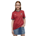 A redheaded woman wearing a red Puma Portugal soccer jersey and a denim skirt against a black background.