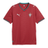 Red Puma Portugal soccer jersey with wavy horizontal patterns, teal trim on the V-neck and sleeves, and the national team crest on the chest.