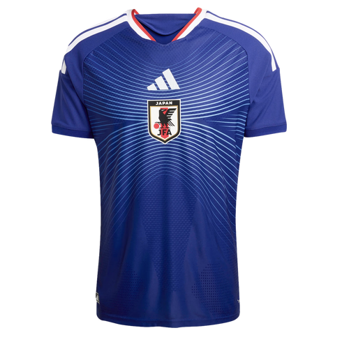 Blue Japan national football team jersey featuring a light blue radiating line pattern, a white Adidas logo, and the JFA crest. Includes white shoulder stripes and red collar trim.