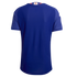 Back view of a blue short-sleeved soccer jersey featuring a small Japanese flag on the collar and a textured fabric pattern.