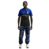 A man wearing a blue and black Inter Milan jersey, blue marble-patterned joggers, and white sneakers, standing against a solid black background.