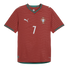 Portugal national team red soccer jersey by Puma, featuring a white number 7, the team crest, and green trim on the v-neck collar and sleeve cuffs.
