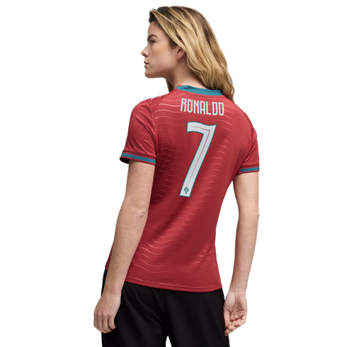 Back view of a woman with blonde hair wearing a red Portugal soccer jersey with "RONALDO" and "7" on the back, against a plain black background.