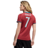 Back view of a woman with blonde hair wearing a red Portugal soccer jersey with "RONALDO" and "7" on the back, against a plain black background.