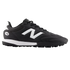 A black New Balance 442 turf soccer shoe featuring a large white 'N' logo and white midsole detail, shown from a side profile against a black background.