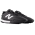 Pair of black New Balance soccer turf shoes featuring a white "N" logo and midsole, shown from a side angle against a black background.