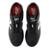 Top-down view of black New Balance 442 soccer cleats with white accents and red insoles on a black background.