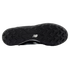 The black rubber sole of a New Balance shoe with chevron-shaped traction studs and a white logo in the center.