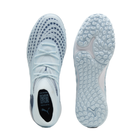 Top and bottom views of a light blue Puma soccer shoe. The top shows a patterned upper and laces, and the bottom features a textured sole with the brand logo.