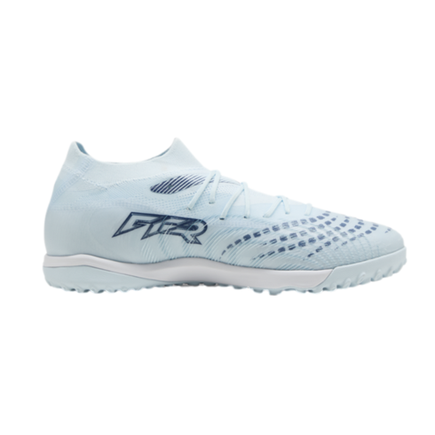 A light blue soccer turf shoe with a dark blue "GTR" logo and textured upper, shown from a side profile against a black background.