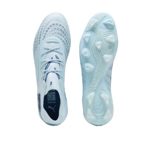 Top and bottom views of light blue Puma soccer cleats against a black background, showing the laces, textured soleplate, and studs.