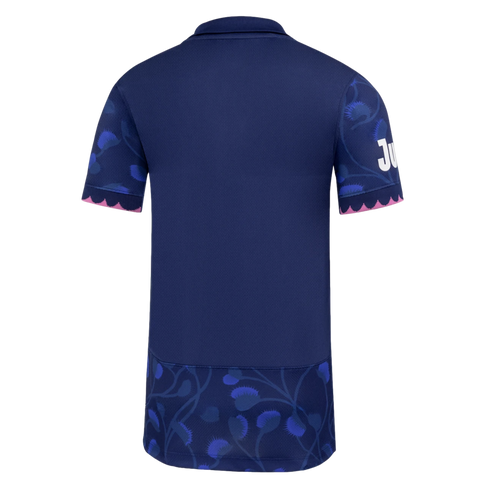 The back of a navy blue polo shirt with blue floral patterns on the sleeves and bottom panel, featuring pink scalloped trim on the sleeve cuffs.