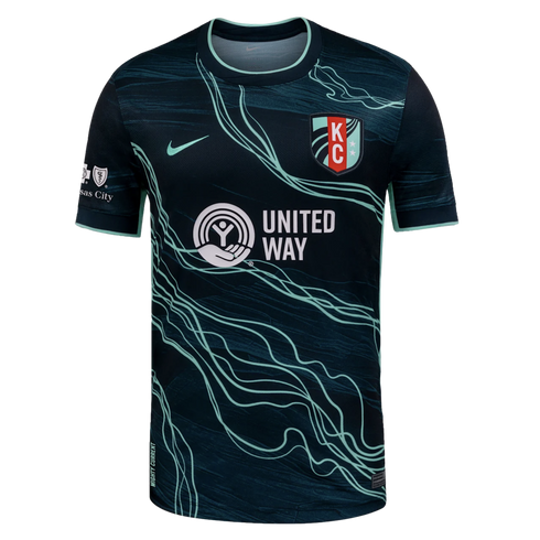 Navy soccer jersey with teal wavy lines, Nike logo, KC team crest, and white United Way sponsor logo. Teal accents on collar and cuffs.