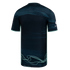 Back view of a dark teal soccer jersey featuring mint green side piping and light green wavy line graphics at the bottom hem.