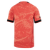 Back view of a red short-sleeved jersey featuring an abstract tonal graphic print and black bands on the sleeve cuffs.