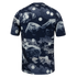 Rear view of a dark blue short-sleeved t-shirt featuring an abstract grey and white rock formation print with white polka dots.