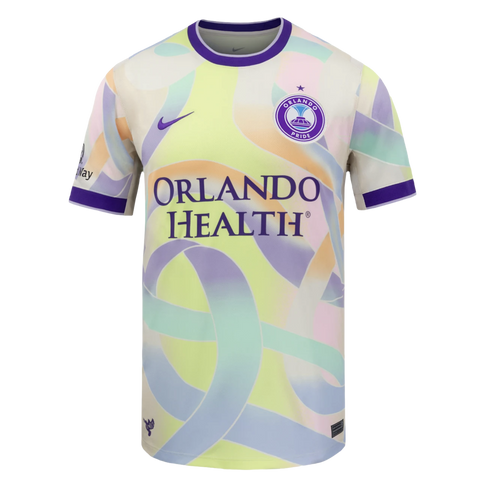 Orlando Pride jersey with a pale yellow base and pastel ribbon patterns. Features a purple collar, Nike logo, team crest, and "ORLANDO HEALTH" sponsor logo.