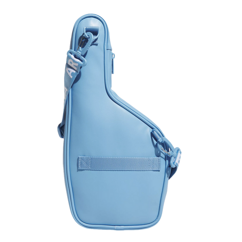 A light blue asymmetrical bag with a matching adjustable shoulder strap, shown against a solid black background.