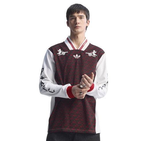 Man modeling a long-sleeved maroon and white Adidas jersey with "AFC" patterns and cherub graphics against a solid black background.