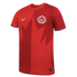 A red Nike Canada national team soccer jersey with a two-tone design split vertically down the middle. A large, stylized dark red maple leaf graphic is centered on the front, with a white Nike swoosh on the right chest and the Canada Soccer crest on the l