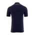 A back view of a navy blue short-sleeved soccer jersey against a solid black background. Near the collar, there is a small Colombian flag above the copper-colored Spanish text, "SOÑAR TRASCENDER Y HACER HISTORIA." The sleeve cuffs are accented with a matc