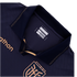 A close-up of the collar and upper chest of a navy blue sports jersey. It features a polo collar with copper-gold dotted trim, the "marathon" brand name on the chest and an inner tag, and a portion of a geometric crest at the bottom.